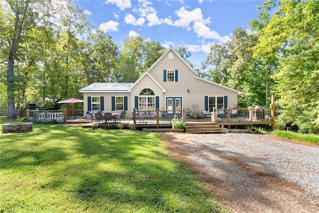 back of house with a lawn and a deck