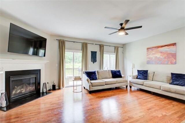 3622 Utoy Dr, South Fulton, GA 30331 - living area featuring wood finished floors, a ceiling fan, and a glass covered fireplace