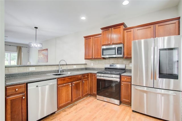 3622 Utoy Dr, South Fulton, GA 30331 - kitchen with appliances with stainless steel finishes, a sink, brown cabinets, tasteful backsplash, and recessed lighting