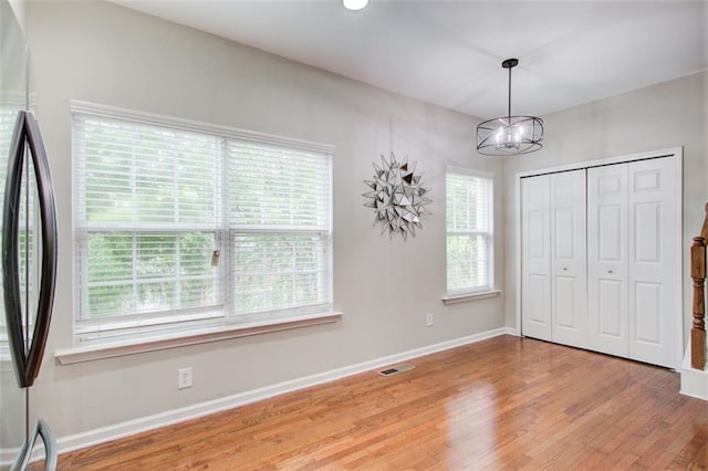 3622 Utoy Dr, South Fulton, GA 30331 - unfurnished bedroom featuring stainless steel fridge, a chandelier, light wood-type flooring, baseboards, and a closet