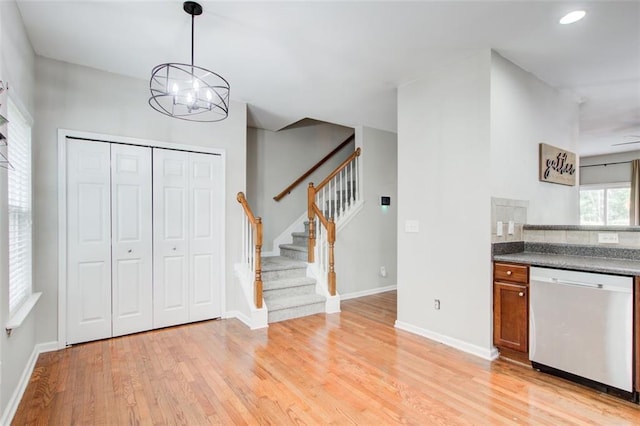 3622 Utoy Dr, South Fulton, GA 30331 - kitchen with dishwasher, light wood finished floors, a chandelier, brown cabinets, and baseboards