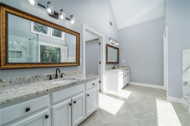 bathroom with vanity, lofted ceiling, and walk in shower