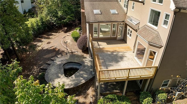 exterior space featuring a deck and a fire pit