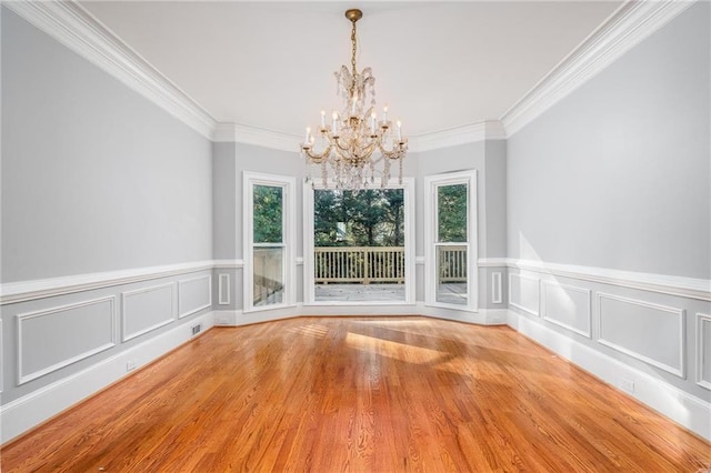 unfurnished dining area featuring light hardwood / wood-style floors, ornamental molding, and a wealth of natural light