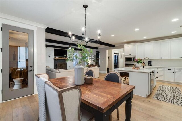 811 Walnut River Trl, Hoschton, GA 30548 - dining area with light wood-style floors, recessed lighting, and a notable chandelier