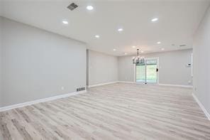 spare room featuring light hardwood / wood-style floors