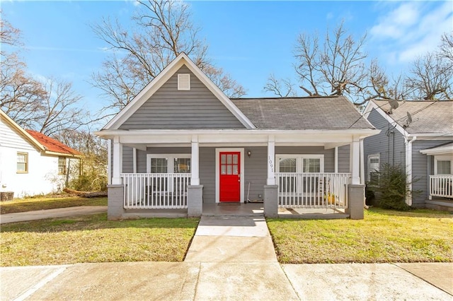 bungalow-style home featuring a front yard and covered porch