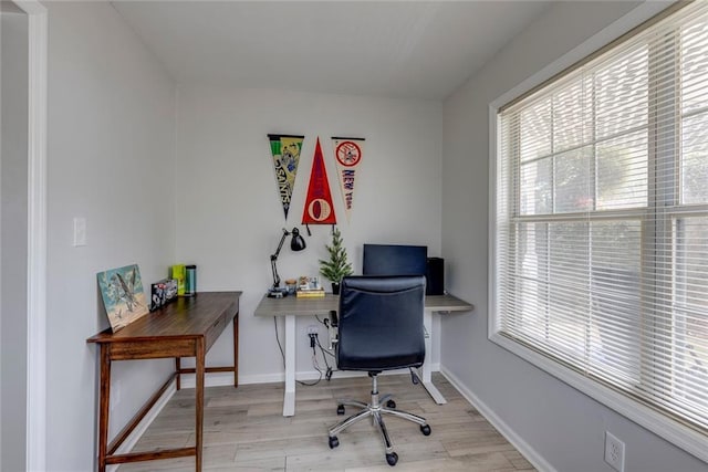 office with light wood-type flooring