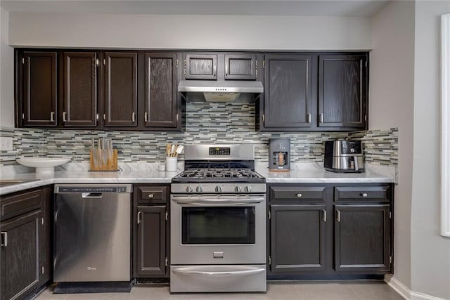 kitchen featuring decorative backsplash, appliances with stainless steel finishes, dark brown cabinets, and light tile patterned flooring