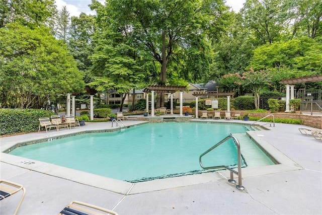 view of swimming pool featuring a pergola and a patio