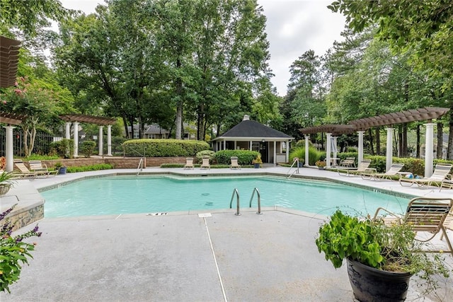 view of swimming pool featuring a pergola and a patio area