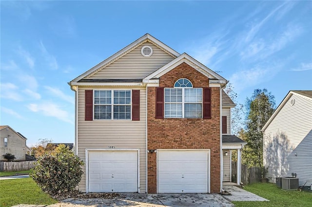 traditional-style home with a garage, brick siding, fence, central AC, and a front yard