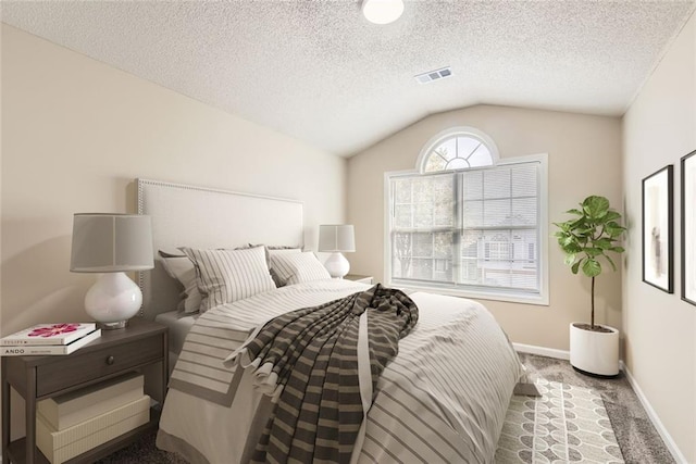 carpeted bedroom featuring lofted ceiling, baseboards, visible vents, and a textured ceiling