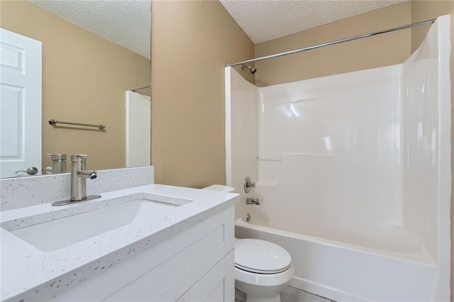 bathroom with toilet, tub / shower combination, a textured ceiling, and vanity