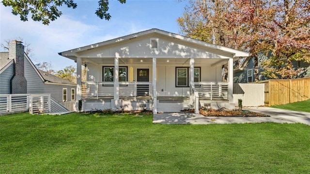 back of house with a porch and a lawn