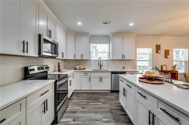 kitchen featuring white cabinetry, visible vents, appliances with stainless steel finishes, and a sink