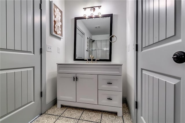 full bathroom with vanity, tile patterned floors, a shower, and baseboards