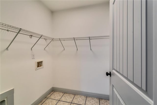 clothes washing area with laundry area, hookup for a washing machine, and baseboards