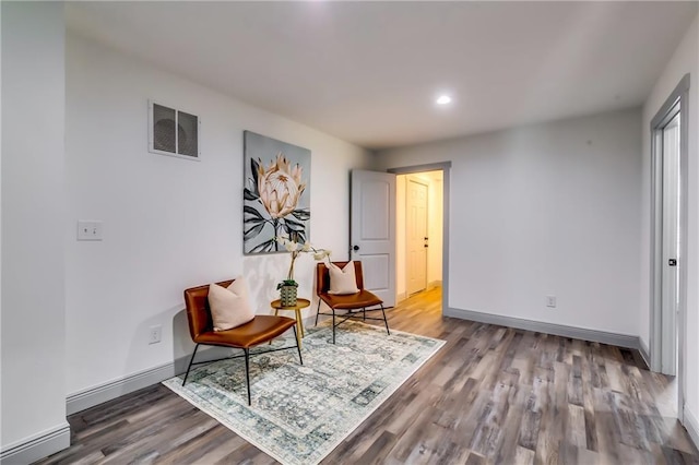 sitting room featuring wood finished floors, recessed lighting, baseboards, and visible vents