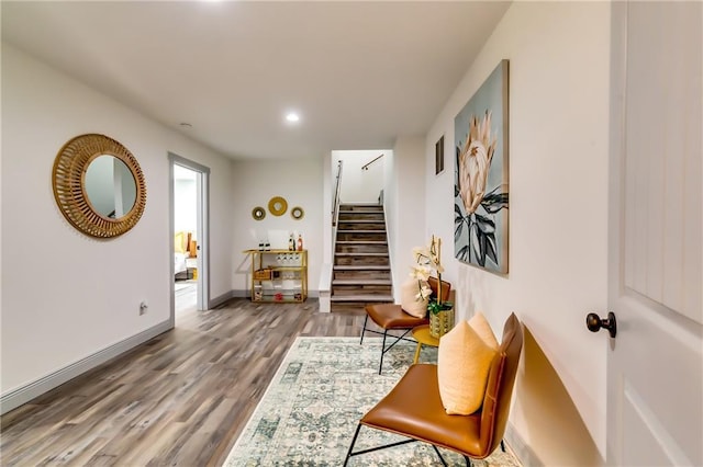 living area with visible vents, baseboards, stairs, recessed lighting, and wood finished floors