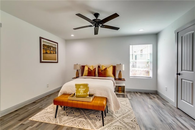 bedroom with recessed lighting, wood finished floors, baseboards, and ceiling fan