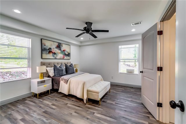 bedroom with recessed lighting, wood finished floors, visible vents, and baseboards