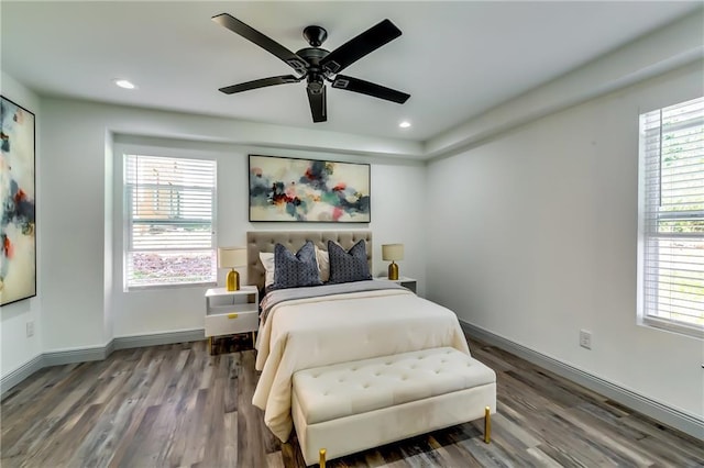 bedroom featuring multiple windows and wood finished floors