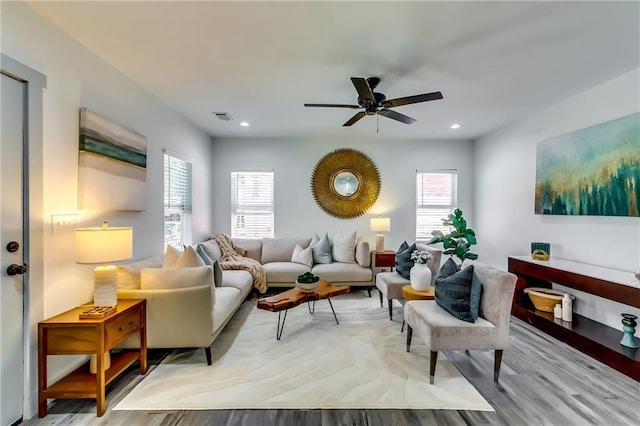 living area with recessed lighting, visible vents, a wealth of natural light, and ceiling fan