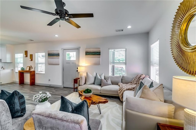 living area featuring a wealth of natural light, visible vents, recessed lighting, and wood finished floors