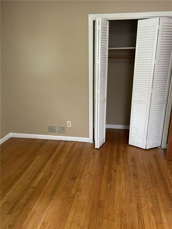 unfurnished bedroom with hardwood / wood-style flooring