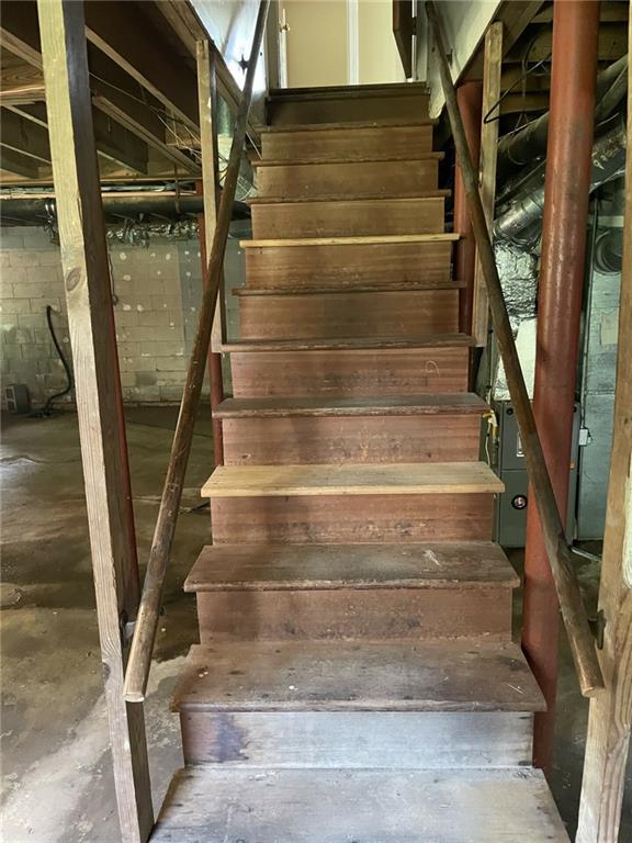 stairway featuring concrete flooring