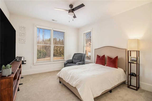 bedroom with ceiling fan and light carpet