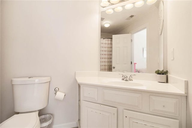 bathroom featuring ornamental molding, vanity, toilet, and curtained shower