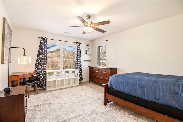 bedroom featuring light colored carpet and ceiling fan