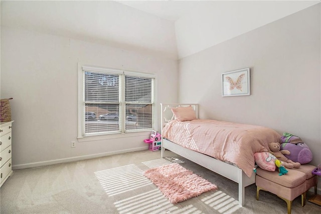 bedroom featuring lofted ceiling and light carpet