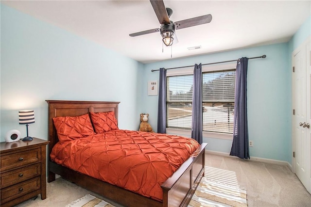 bedroom featuring light carpet and ceiling fan