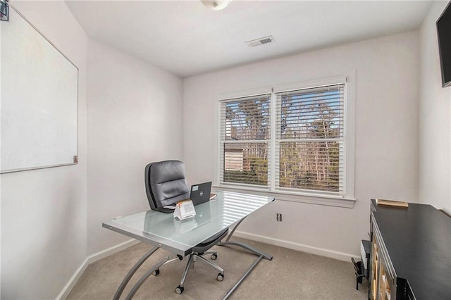 office area featuring light carpet