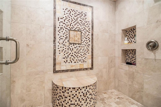 bathroom featuring a shower with shower door