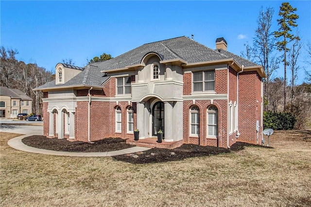 view of front of property with a garage and a front lawn