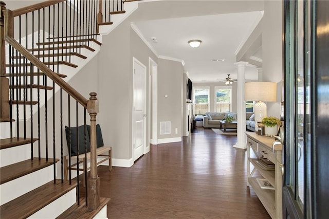 entryway with visible vents, wood finished floors, stairs, and crown molding