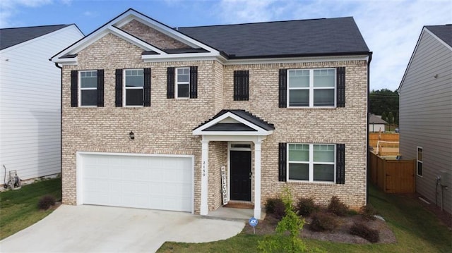 2159 Redfern Rd, Dacula, GA 30019 - view of front of home with brick siding, an attached garage, and driveway