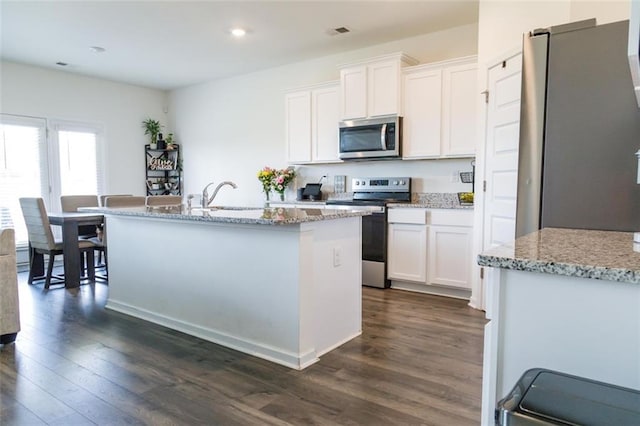 2159 Redfern Rd, Dacula, GA 30019 - kitchen with stainless steel appliances, dark wood-style floors, white cabinets, and recessed lighting