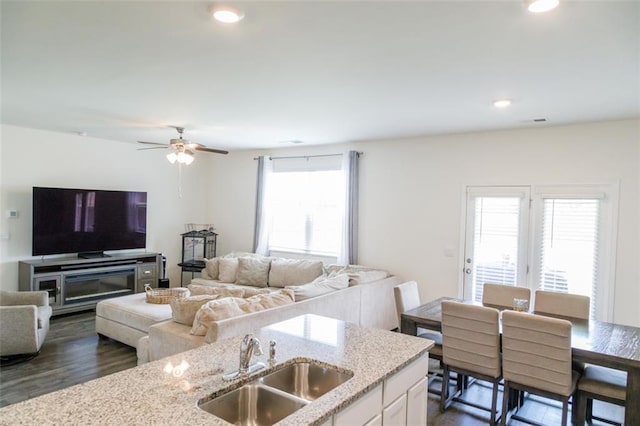 2159 Redfern Rd, Dacula, GA 30019 - kitchen with open floor plan, light stone counters, dark wood-type flooring, white cabinets, and ceiling fan