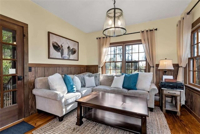 living room with hardwood / wood-style floors and wooden walls