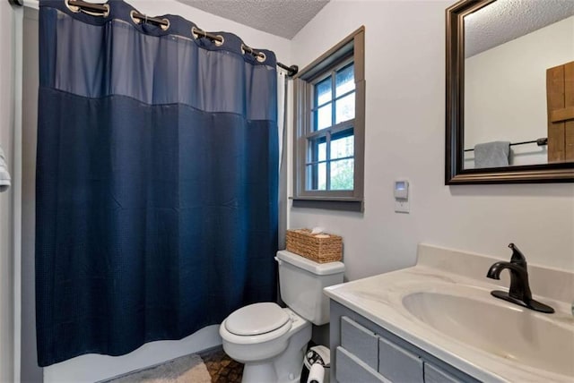 bathroom featuring vanity, a textured ceiling, toilet, and curtained shower