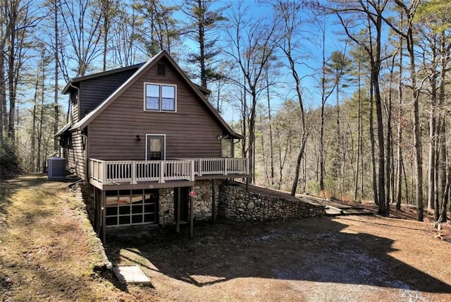 back of property featuring cooling unit and a deck