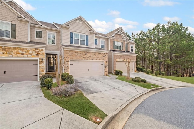 townhome / multi-family property featuring concrete driveway and an attached garage