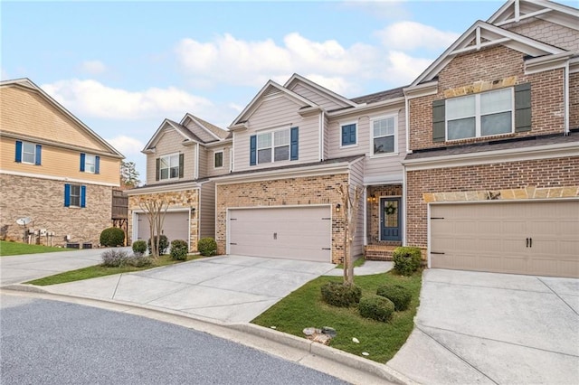 craftsman-style home featuring a garage, brick siding, and concrete driveway