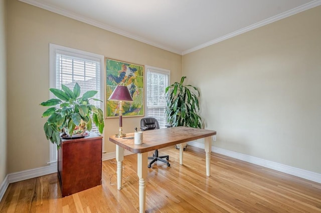 office area featuring light wood-type flooring, crown molding, and baseboards