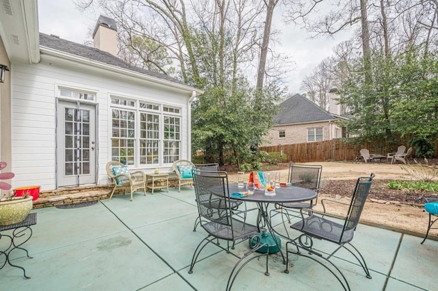 view of patio featuring outdoor dining space and fence